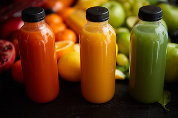 Image showing Colorful bottles filled with fresh fruit and vegetable juice or smoothie