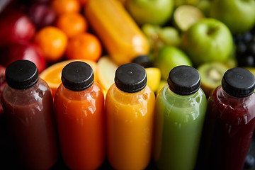 Image showing Colorful bottles filled with fresh fruit and vegetable juice or smoothie