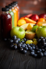 Image showing Colorful bottles filled with fresh fruit and vegetable juice or smoothie