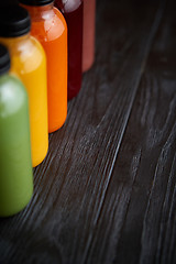 Image showing Colorful bottles filled with fresh fruit and vegetable juice or 