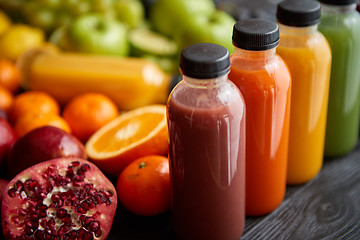 Image showing Colorful bottles filled with fresh fruit and vegetable juice or smoothie