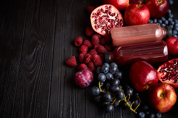 Image showing Mix of fresh red and black fruits. With botteled fresh juices