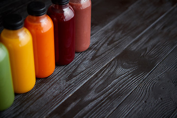 Image showing Colorful bottles filled with fresh fruit and vegetable juice or 