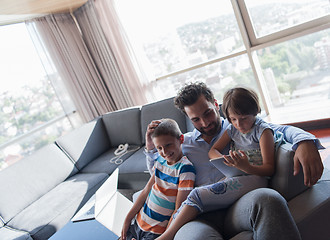 Image showing happy young father spending time with kids