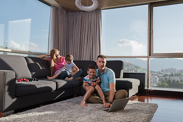 Image showing Happy family playing a video game