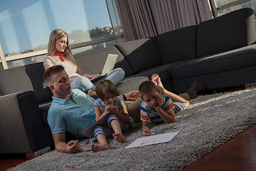 Image showing young couple spending time with kids at home