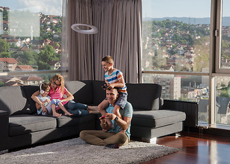 Image showing Happy family playing a video game