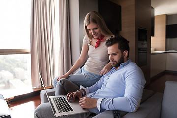 Image showing couple relaxing at  home using laptop computers