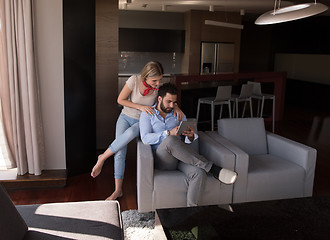 Image showing couple relaxing at  home with tablet computers