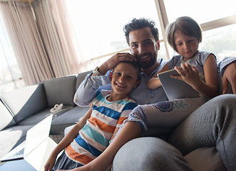 Image showing happy young father spending time with kids