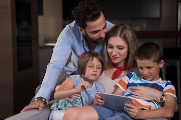 Image showing happy young couple spending time with kids