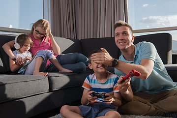 Image showing Happy family playing a video game