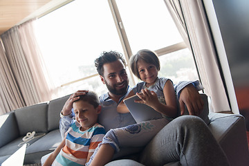 Image showing happy young father spending time with kids