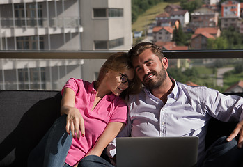 Image showing couple relaxing at  home using laptop computers