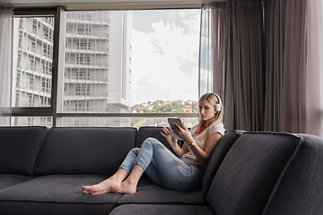 Image showing young girl enjoying music through headphones