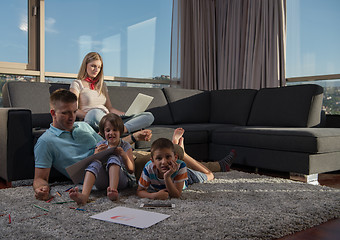 Image showing young couple spending time with kids at home