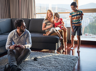 Image showing Happy family playing a video game