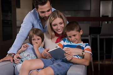 Image showing happy young couple spending time with kids