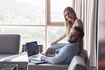 Image showing couple relaxing at  home using laptop computers