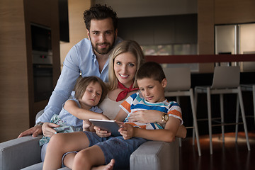 Image showing happy young couple spending time with kids