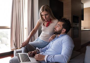 Image showing couple relaxing at  home using laptop computers