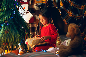 Image showing happy girl reading a book in the winter