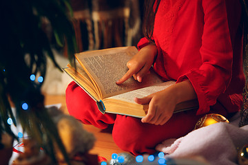 Image showing happy girl reading a book in the winter