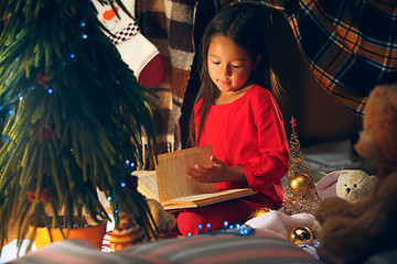Image showing happy girl reading a book in the winter