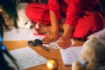 Image showing Beautiful girl holding her hands with snowflakes from the paper