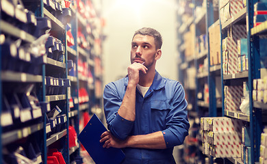 Image showing auto mechanic with clipboard at car workshop