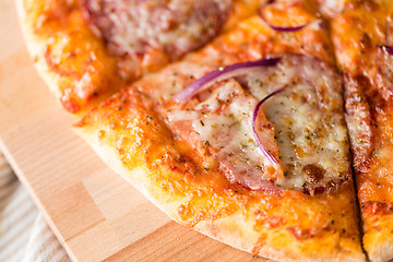 Image showing close up of homemade pizza on wooden table