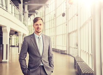 Image showing young businessman in suit at office building hall