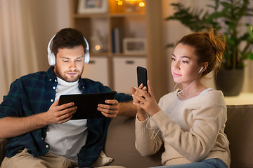 Image showing couple with gadgets listening to music at home