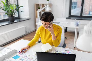 Image showing happy ui designer calling on smartphone at office