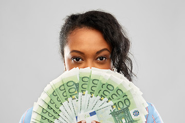 Image showing african american woman hiding face behind money