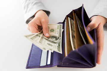 Image showing close up of woman hands with wallet and us money