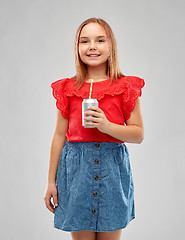 Image showing smiling preteen girl drinking soda from can