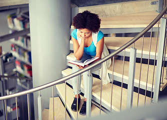 Image showing african student girl reading book at library