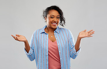 Image showing clueless african american woman shrugging