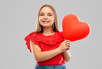 Image showing smiling girl with red heart shaped balloon