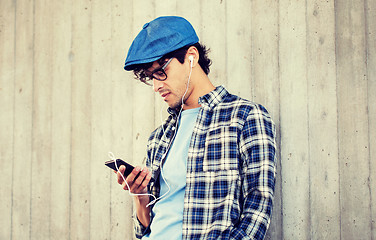 Image showing man with earphones and smartphone listening music