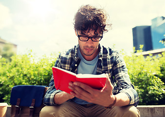 Image showing man with notebook or diary writing on city street