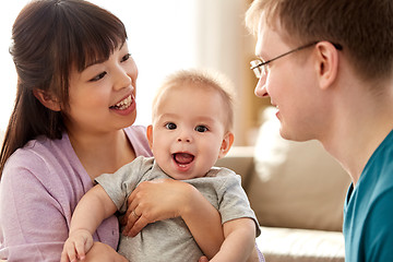 Image showing happy mixed-race family with baby son at home
