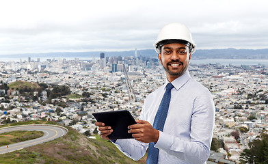 Image showing architect or businessman in helmet with tablet pc