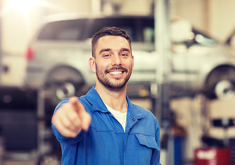 Image showing happy auto mechanic man or smith at car workshop