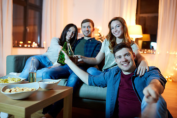 Image showing happy friends taking selfie at home party