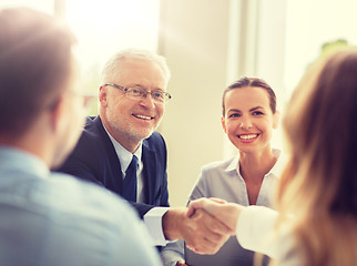 Image showing senior businessman making handshake at office