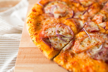 Image showing close up of homemade pizza on wooden table