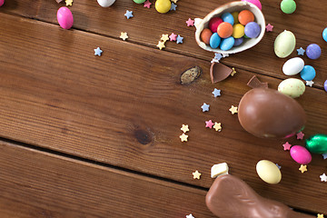 Image showing chocolate eggs, easter bunny and candies on wood