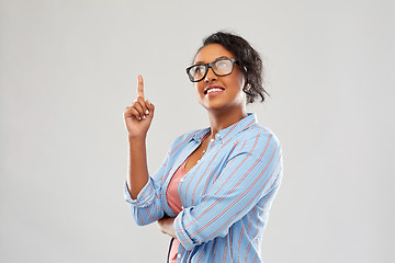 Image showing african student woman in glasses points finger up